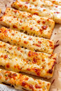 several slices of pizza sitting on top of a wooden cutting board