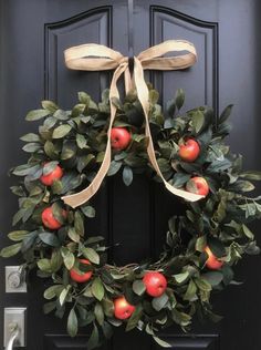 an apple wreath is hanging on the front door