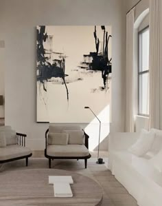 a living room filled with furniture and a painting on the wall