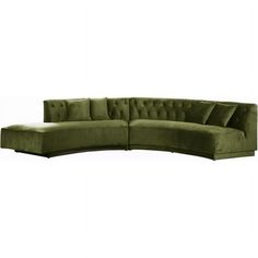 a green sectional sofa with pillows on it's back and arms, in front of a white background