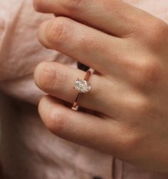 a woman's hand with a diamond ring on it