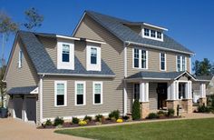 two story house with white windows and gray roof