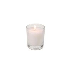 a small white candle sitting on top of a table