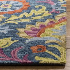 a blue rug with colorful flowers on it