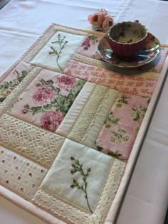 a close up of a table with a plate on it and flowers in the center