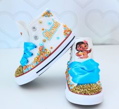 a pair of white sneakers with blue and gold sequins on the bottom, featuring princess pooh