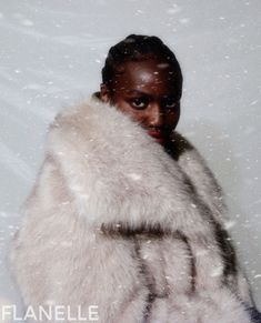 a woman wearing a fur coat in the snow