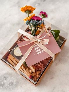 an open box with some flowers in it