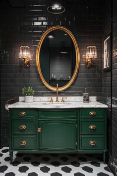 a bathroom with black and white flooring, green cabinets and a round mirror on the wall