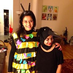 two women standing next to each other in a living room