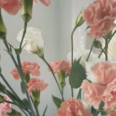 pink and white flowers are in a vase