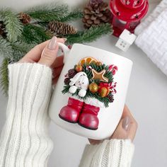 a person holding a coffee mug with christmas decorations on it