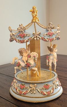 an elaborately decorated carousel on a wooden table