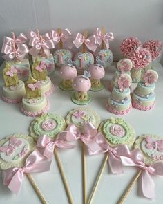 a table topped with lots of cake and cupcakes