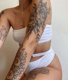 a woman with tattoos on her arm and leg