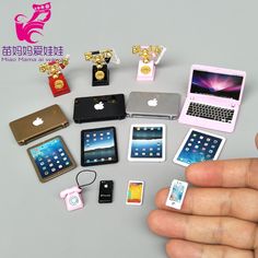 a hand is holding an assortment of cell phones and gadgets