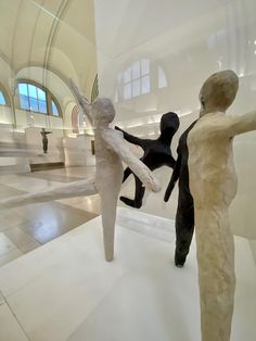 two sculptures are shown in the middle of a room