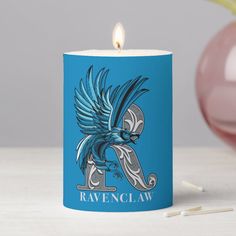 a blue candle with the ravenclaw logo on it