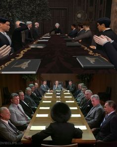 people sitting at a long table in suits and ties