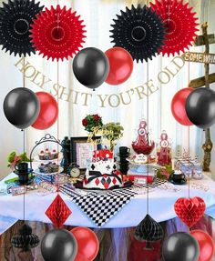 a table topped with black and red balloons