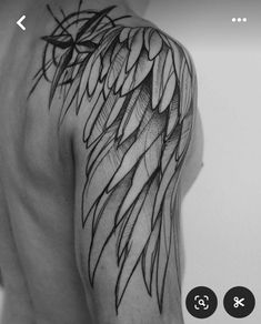 a black and white photo of a man's arm with wings on it