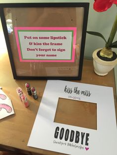 there is a picture frame and some lipstick on the table