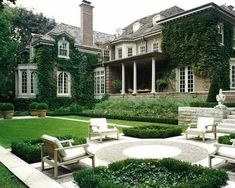 a large house with lots of greenery in the front yard