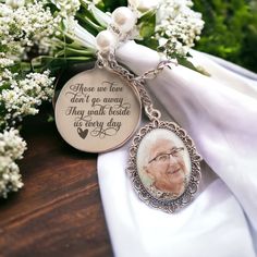 a keychain with an image of a man on it and flowers in the background