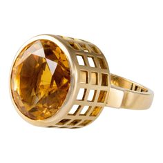 A citrine and 18 karat gold ring, by Sweden's most important and most versatile modernist designer, Sigurd Persson, c. 1955. This ring is a size 5 and stamped with maker marks SIGP, Swedish hallmarks, and 18k. It is highly collectible and comes with its original box. Persson had a way of showcasing the luminosity of the stones he used. If you look at a variety of his rings, you will see his design inclination towards gold grids with cutouts rising high above the shank, in which he exposes the st Modern Gold Topaz Ring, Modern Yellow Gold Topaz Ring With Polished Finish, Modern Gold Topaz Ring, Hallmarked, Modern Citrine Rings For Formal Occasions, Modern Yellow Gold Citrine Ring, Modern Citrine Ring In Yellow Gold, Modern Citrine Yellow Gold Ring, Vogue Jewelry, Modernist Design