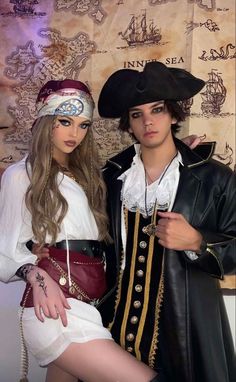 two people dressed in pirate costumes posing for the camera