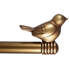 a gold colored bird figurine sitting on top of a metal rod with a white background