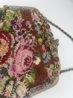 "Vintage Beaded Ladies Purse is covered with Large Roses and other smaller flowers. It has a top frame that is rimmed on the front with a variety of colored jewels in different sizes and shapes. The handle is twisted chain. It has a two ball clasp to open and close. Inside the fabric lining with braided edge is in great condition. The bottom ends in a bundle of beads  that encompasses a multi string tail making a beaded tassel. It is almost 6\" wide at the frame and hanging approx 17\" from top of handle to bottom of tassel.  This is American ca 1900." Handmade Vintage Multicolor Beads, Gems, And Cabochons, Elegant Multicolor Beaded Gems And Cabochons, Large Roses, Jewel Top, Twisted Chain, Ladies Purse, Beaded Purses, Luggage Sets, Vintage Jewels