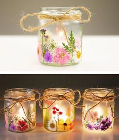 three mason jars with flowers painted on them, one is filled with candles and the other has