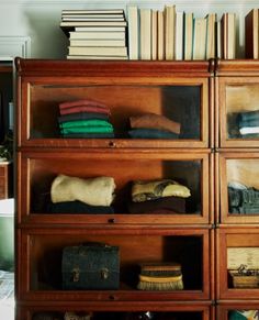 a wooden bookcase filled with lots of books and knick - knacks