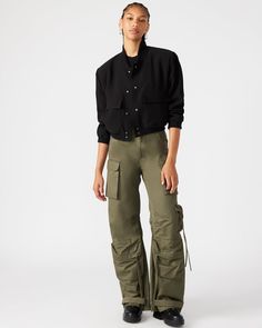 Expertly designed for a structured and voluminous fit, the DUO pant is crafted from midweight cotton twill fabric. With adjustable ankle straps, these wide leg cargo pants offer a versatile silhouette that can be easily customized to your preference. Mid rise cargo pants Zipper fly with shank button closure Two side pockets, two back patch pockets, and five cargo pockets down the legs Bottom 3 cargo pockets feature extended zipper pulls Snap strap at hem to cinch ankles Inseam: 31" 100% cotton H Wide Leg Cargo Pants, Football Game Outfit, Steve Madden Store, Apparel Merchandising, Shank Button, Cargo Pant, Gaming Clothes, Back Patch, Zipper Pulls