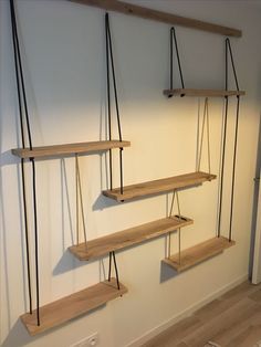 three wooden shelves are hanging on the wall