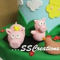 two pigs are sitting on top of a green cake