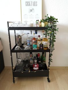 a bar cart filled with liquor bottles and glasses