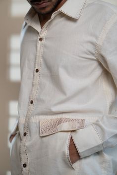 This Dawning Flap Detailed Shirt comes in a calm and soothing color. A contemporary take on the classic long sleeve shirt. This 60s cotton button-down shirt is undyed and unbleached. Details include intricate Kantha stitches, a form of Indian hand embroidery on the faux flaps and pockets. *This item is a final sale and not eligible for returns or exchanges. *This item can take up to 14 business days to ship as it is made to order for you. Traditional Long Sleeve Linen Shirt, Beige Long Sleeve Cotton Shirt, Cream Long Sleeve Shirt With Buttons, Cream Relaxed Fit Shirt With Buttons, Relaxed Fit Cream Shirt With Buttons, Beige Cotton Top With Spread Collar, Traditional Long Sleeve Shirt With Button Closure, Beige Long Sleeve Shirt With Button Cuffs, Traditional Long Sleeve Cotton Shirt