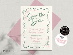 save the date card with pink envelope and green lettering on it, sitting next to an envelope