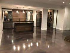 an empty kitchen and living room in a house with metallic flooring on the floors