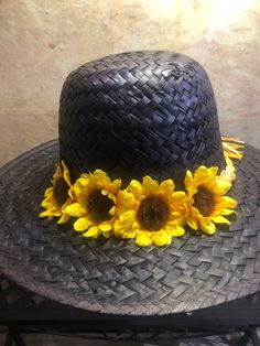 Beautiful lightweight mahogany straw hat with sunflowers and tied raffia band in contrasting shades of sunny yellow and orange. Fits head circumferences from 21 inches to 23 inches. Great hat for any occasion and because the hues are so easy on the eye you're sure to wear it for years to come. Brown Brimmed Costume Hats For Beach, Brown Brimmed Costume Hats And Headpieces For Beach, Festival Straw Sun Hat, Yellow Straw Hat With Short Brim, Yellow Straw Hat With Wide Brim, Yellow Wide Brim Straw Hat, Adjustable Sun Hat With Flower Design For Vacation, Adjustable Flower Hats For Vacation, Adjustable Flower Hat For Beach