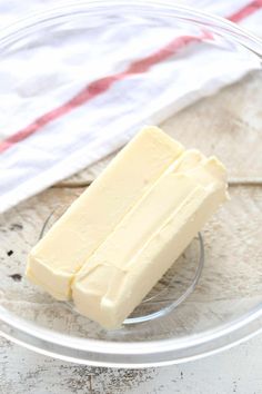 a piece of butter sitting on top of a glass plate