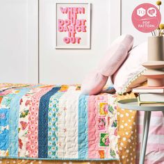 a bed covered in lots of colorful quilts and pillows