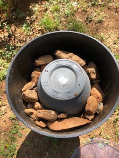 a large metal bowl with rocks in it