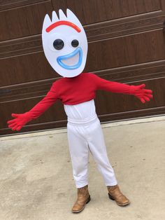 a person in a costume that is standing on the sidewalk with his arms out and hands outstretched