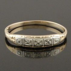 an antique gold wedding ring with roman numerals