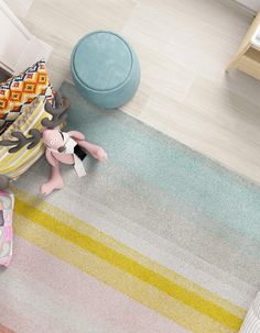 an overhead view of a child's bedroom with colorful rugs and toys on the floor