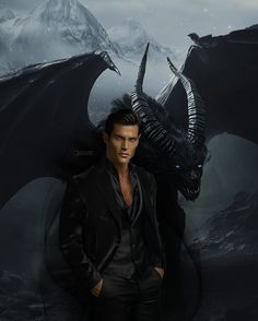 a man standing next to a black dragon