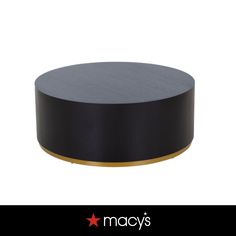 a black and gold round table with the name macy's on it